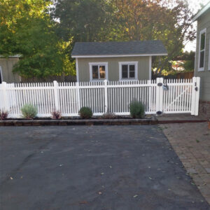 Durham white vinyl picket fencing with gate near driveway