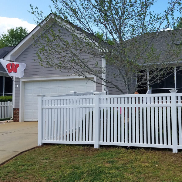 Stanton white vinyl picket fence in front of garage