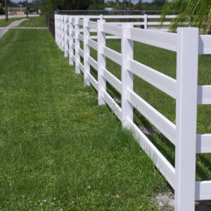 4 rail white vinyl horse fence near sidewalk