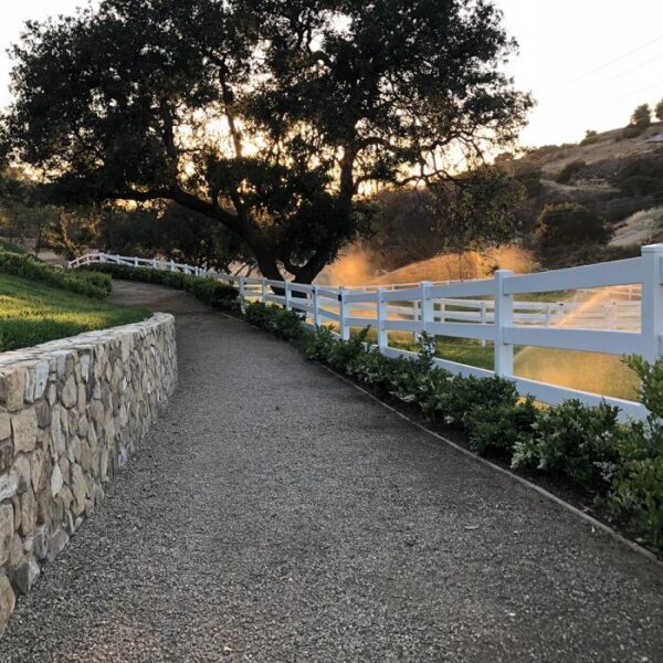 3 rail ranch rail along gravel walkway