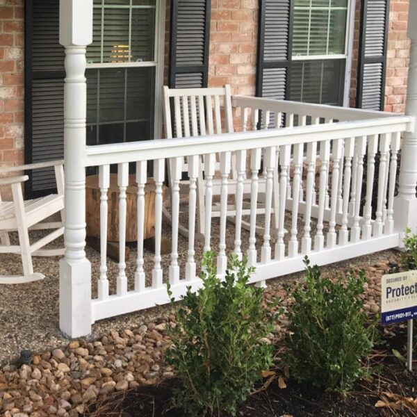 Ashington white vinyl railing on small gravel porch