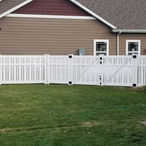 Weldon white semi-privacy fence on green lawn