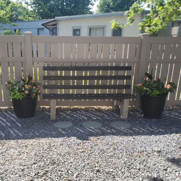 Weldon khaki semi-privacy fence behind bench