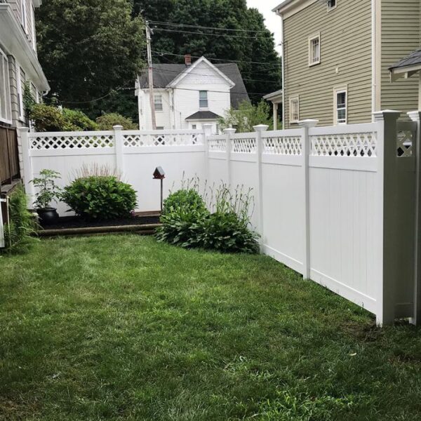 Canterbury white vinyl privacy fence in side yard