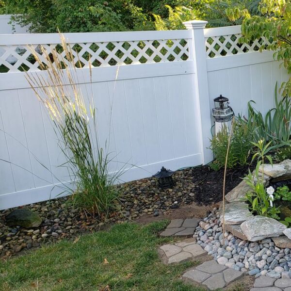 Canterbury white vinyl privacy fence and spiky grass