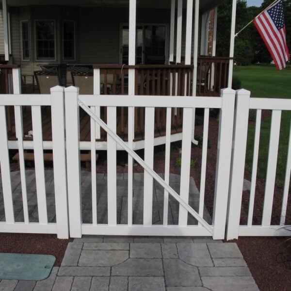 Cargill white vinyl pool fence gate on stone path