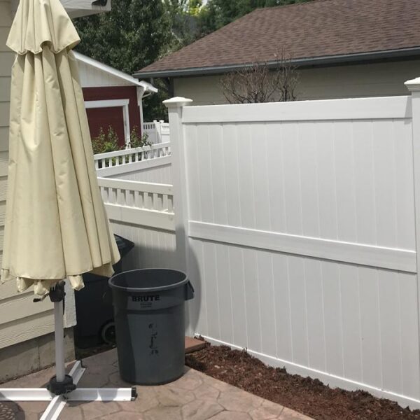 Newport white vinyl privacy fence with closed umbrella