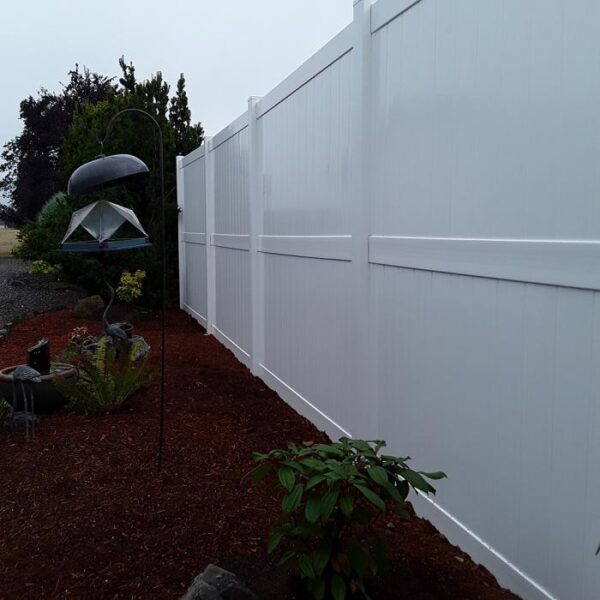 Newport white vinyl privacy fence long view