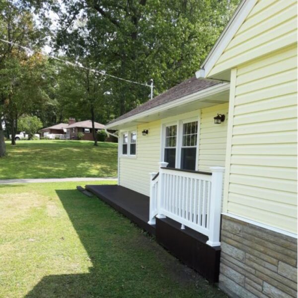 Bexley white vinyl railing on yellow house alternate angle