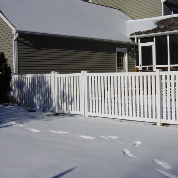 Stanton white vinyl pool fence gate in the snow with footprints