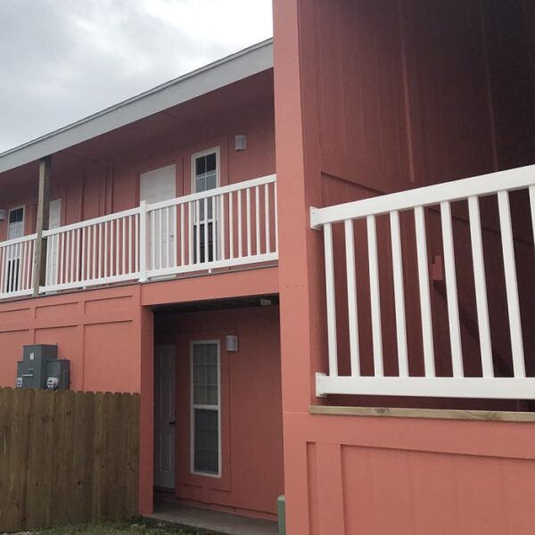 Waltham white vinyl railing on red house