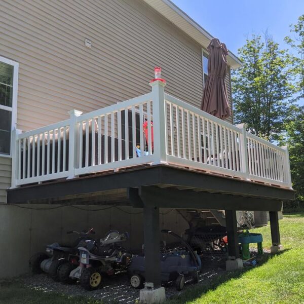 Waltham white vinyl railing over storage area.