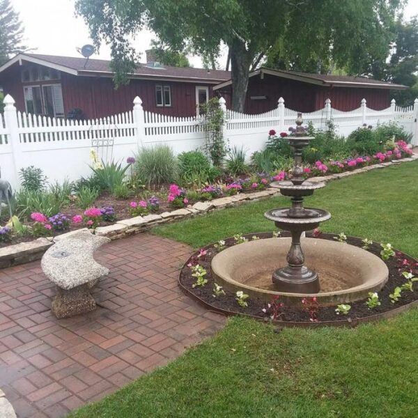 Turnbridge white vinyl privacy fence behind fountain