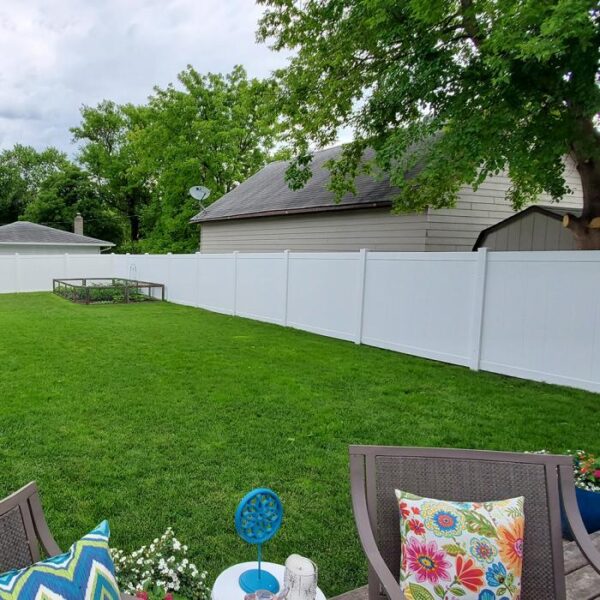 Wendell white vinyl privacy fence with corner garden