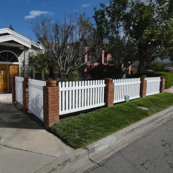 Sudbury white vinyl picket fence with brick posts