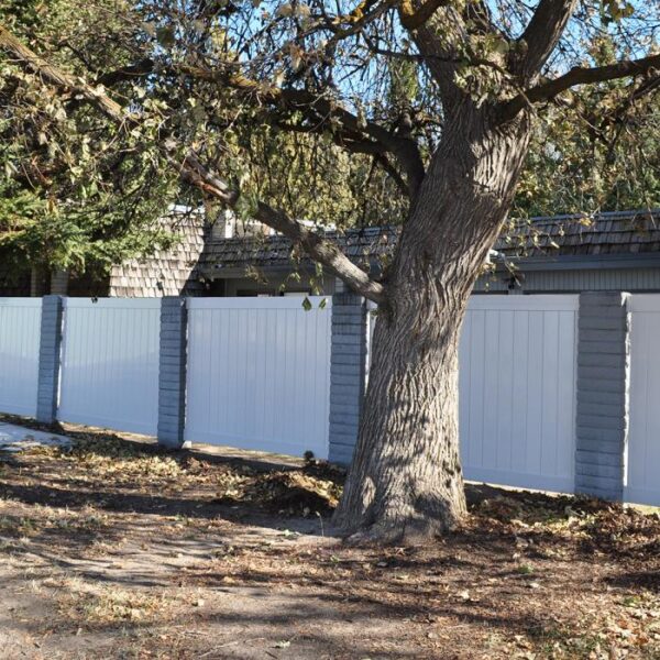 Ashforth white vinyl privacy fence with stone pillars