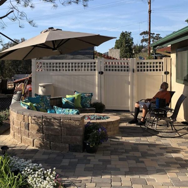 Briston white vinyl privacy fence by brick fire pit