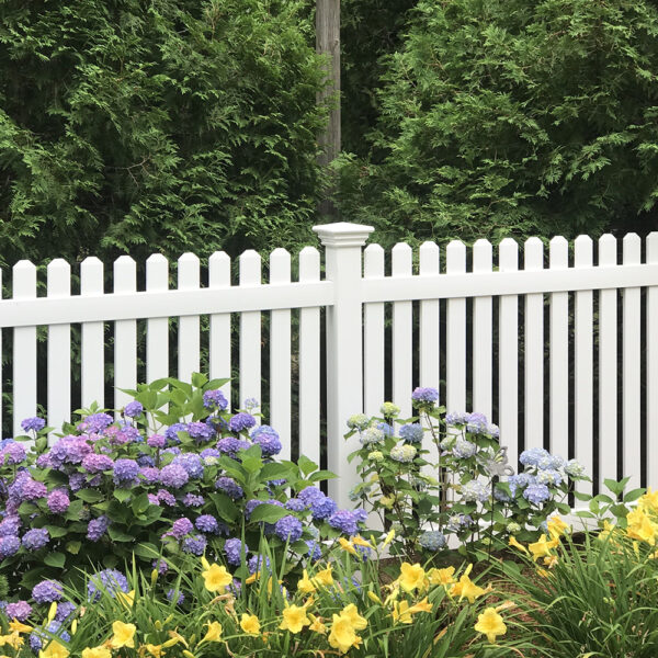 Sudbury white vinyl picket fence in behind flower garden