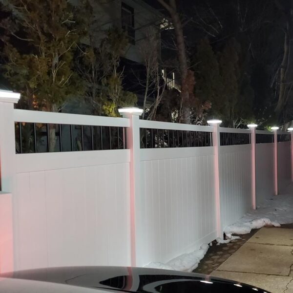 Florence white vinyl privacy fence on snowy driveway